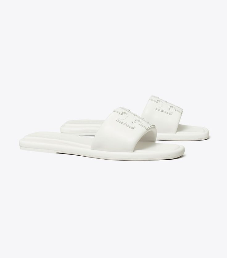 Classic Flat Slides With Removable Insole, Classic Cushioned Slip-on Slides, White Leather Slides With Textured Sole, Classic Cushioned Slides, Luxury Slides With Textured Footbed For Spring, Classic Slides With Rubber Sole, Classic Open Toe Slides With Textured Sole, Classic Flat Slides For Spring, Classic Spring Slide Slides