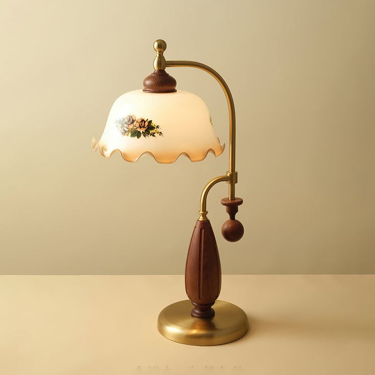 a lamp that is sitting on top of a table with a wooden base and white glass shade