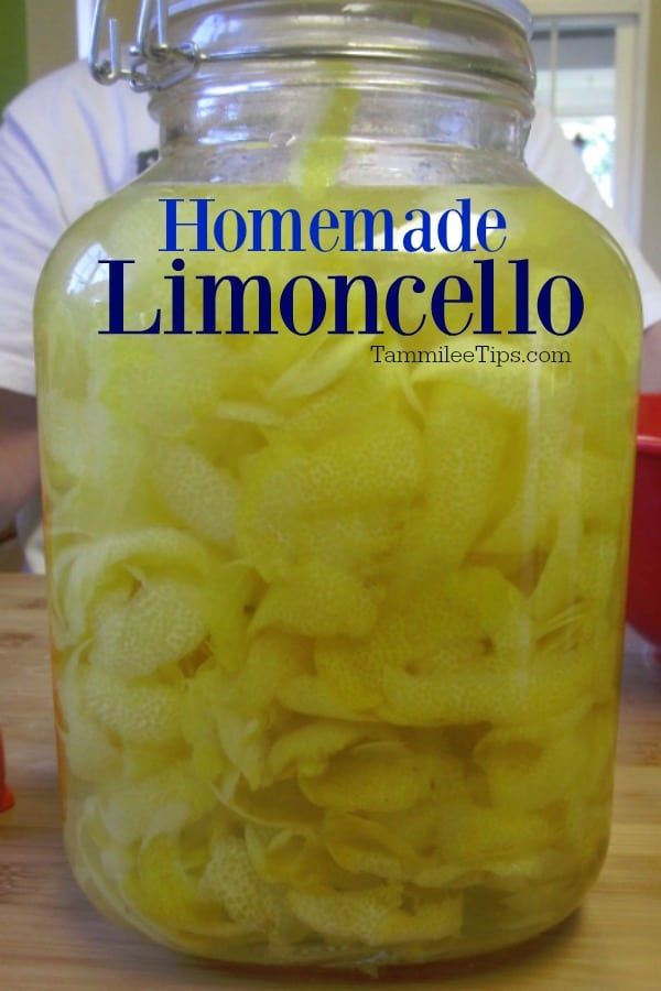 a jar filled with lemons sitting on top of a wooden table