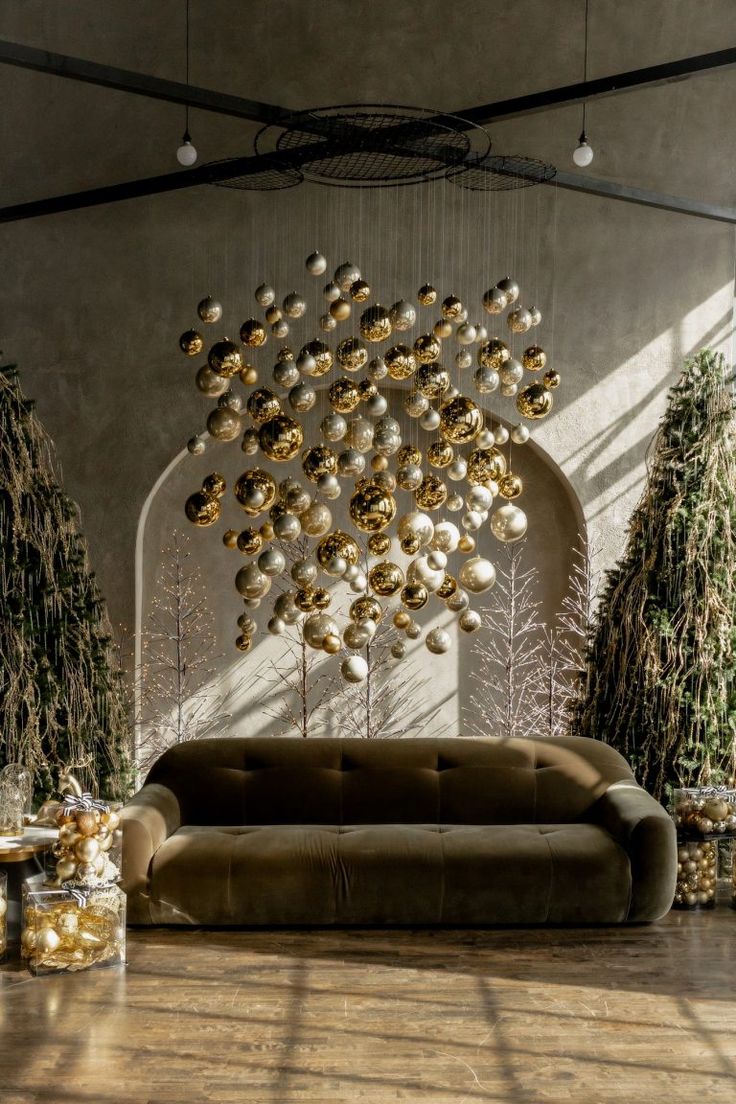 a living room filled with lots of furniture and christmas ornaments hanging from the ceiling above