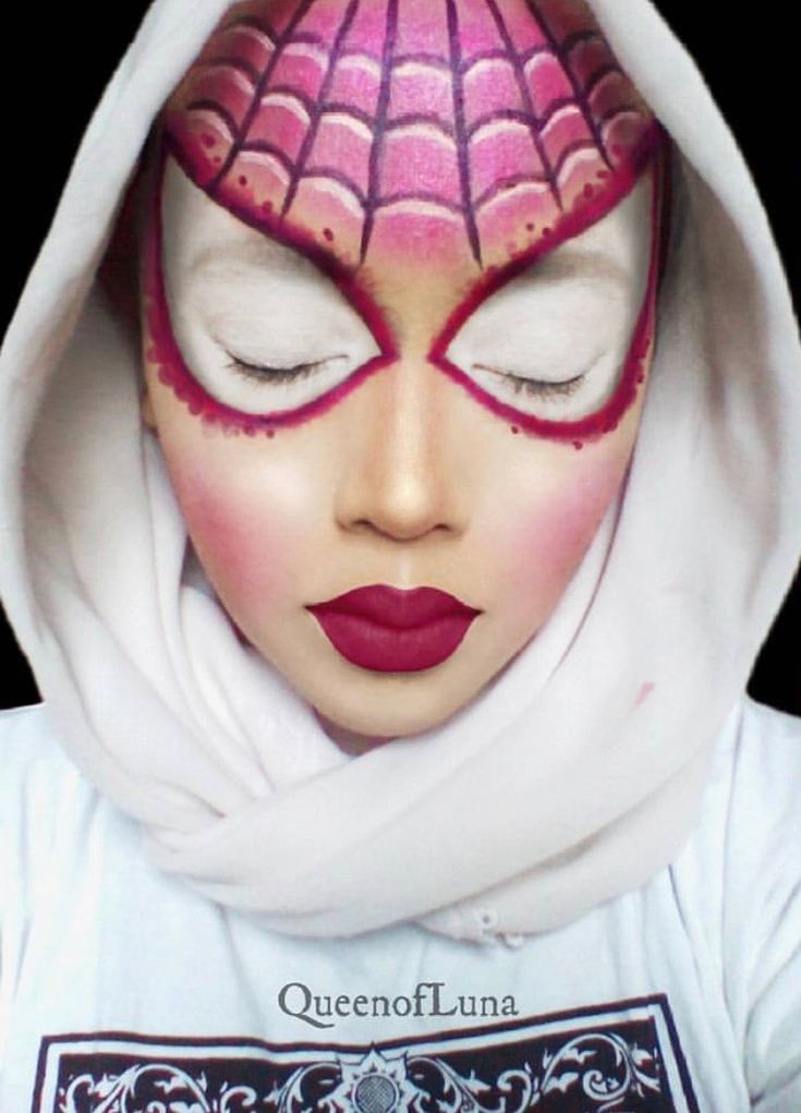 a woman with her face painted like a spider - man, wearing a white hoodie