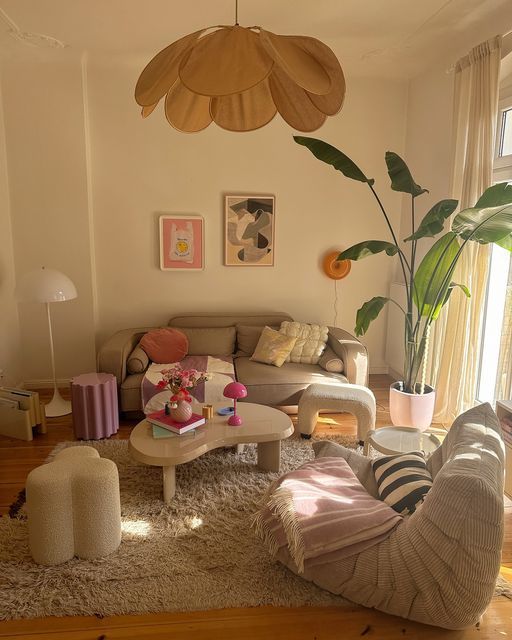 a living room filled with furniture and a large plant in the middle of the room