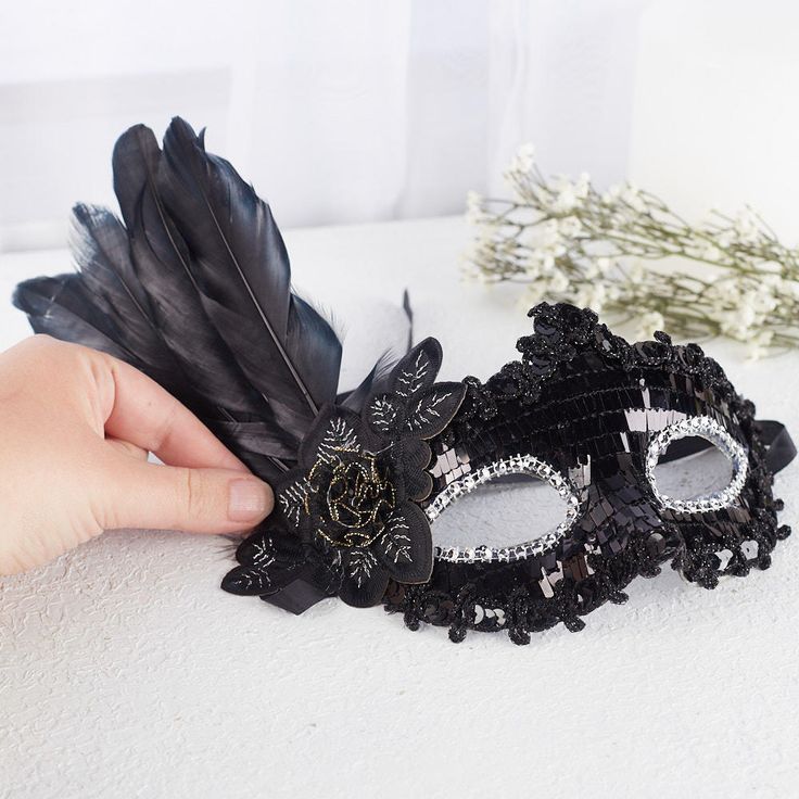 Black Feathered disguise. Whether for Halloween or a fancy masquerade this Black Feathered disguise will be give you that classy look.    The detailing of the disguises complements a costume or plain dress for a simple-yet-charming disguise. The attached feathered accent, along with rose offer a dramatic look.    One size fits most Elegant Halloween Masquerade Masks And Prosthetics, Black Fantasy Masks And Prosthetics For Costume Party, Halloween Theater Masquerade Mask, Black Fantasy Costume Accessories For Theater, Black Fantasy Costume Accessories For Carnival, Elegant Halloween Costume Eye Mask, Elegant Halloween Eye Mask, Elegant Eye Mask For Halloween, Halloween Eye Mask For Costume Party