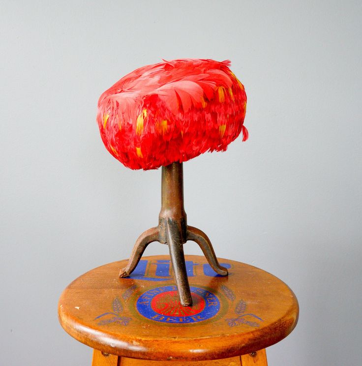 "DESCRIPTION * Vintage hat from 1950s-1960s, made in Belgium * pillbox design: brimless, round crown, fitted to the head * lined with felt material with wired frame * made with two types of red feathers: top of the hat is decorated with bigger feather and the side is composed of red and yellow feather * tag reads \"Eurona, Made in Belgium\" CONDITION * The hat is in good condition, with minor loose feather as shown in the last photo. SIZE hat circumference 21.5\" hat height 4\" top diameter 8\"" Red Vintage Mini Hats For Kentucky Derby, Vintage High Crown Mini Hat For Parties, Vintage Red Mini Hat For Kentucky Derby, Adjustable Vintage Hats For Races, Red Vintage Adjustable Top Hat, Vintage Red Costume Hat With Short Brim, Vintage Red Adjustable Top Hat, Red Vintage Costume Hat With Short Brim, Vintage Red Adjustable Mini Hats