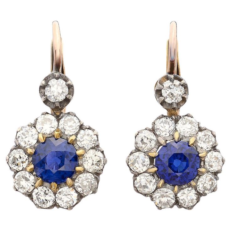 Exceptional stones meet classic design in these beautiful sapphire and diamond drop earrings. Made of 18 karat gold, at the center of each of these gorgeous earrings is a fine round vibrant blue sapphire weighing 0.80 carats (1.60cttw) surrounded by a halo of fine white natural old cut diamonds and a single diamond suspended above each halo, for a total diamond weight of 1.65 carats. The earrings hang just under 1.0" long and weigh 4.1 grams total, while the old cut diamonds average G-H color and VS2-SI1 clarity, delivering more than enough sparkle! Treat yourself or someone you love to some ear candy! Yellow Gold Drop Earrings, Blink Blink, Vintage Drop Earrings, Sapphire And Diamond Earrings, White Gold Sapphire, Diamond Dangle Earrings, Long Dangle Earrings, Diamond Drops, Diamond Drop Earrings