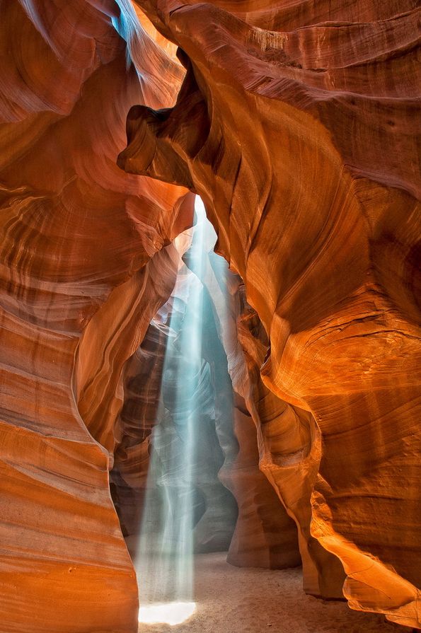 the light shines through an open slot in antelope's canyon, arizona