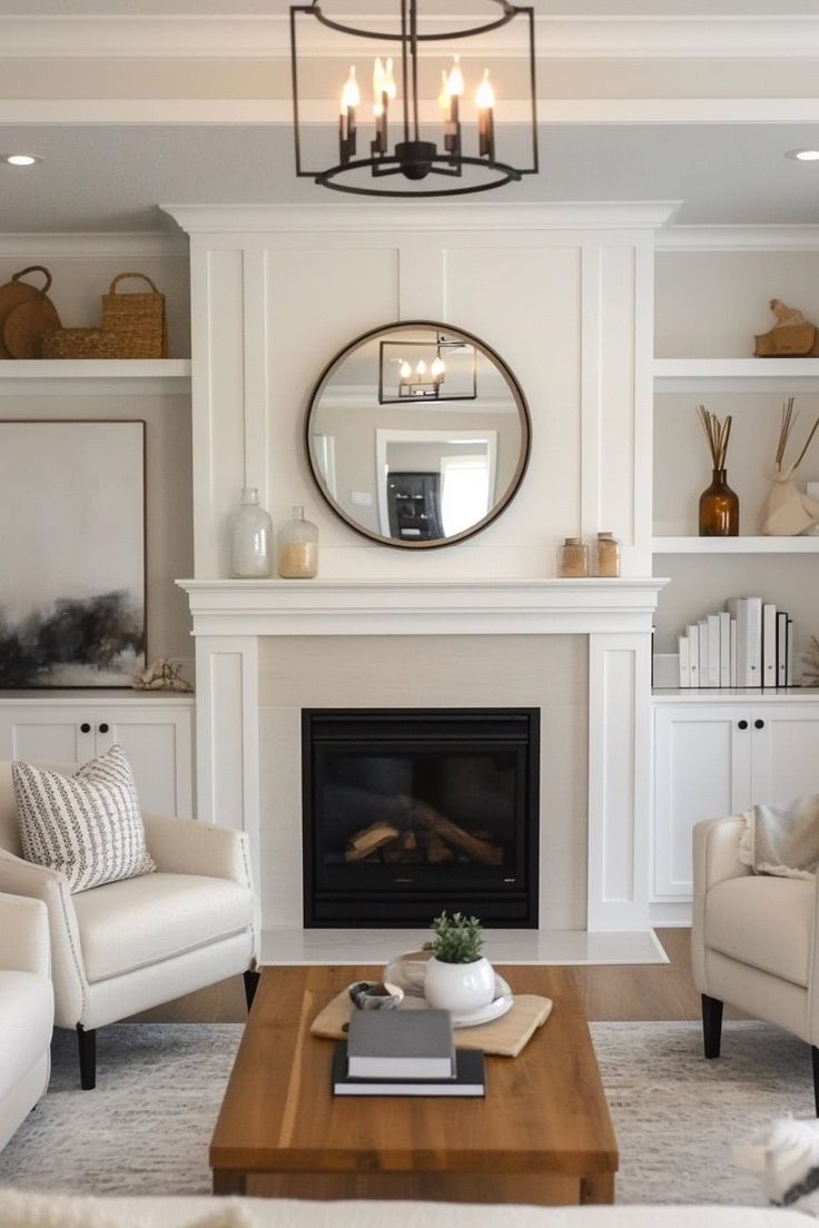 a living room filled with furniture and a fire place in front of a mirror on the wall