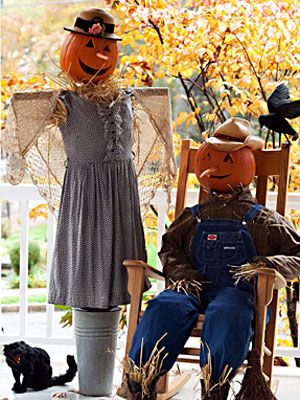 two scarecrows sitting in chairs on the porch with their heads turned to look like pumpkins