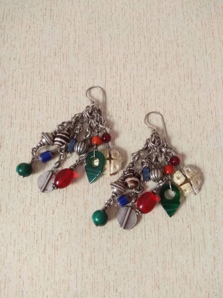 This is a beautiful silver berber earrings from Morocco with Talhakimt, Old Coral bead, small silver berber pendant, stones, and shell. These earrings have a good size and weight to be worn. Length : 8,3 cm (3,2 inches) Diameter of items : 0,4 cm to 1,2 cm (0,1 inches to 0,4 inches) Weight : 35,2 g Unique Silver Metal Beaded Earrings, Traditional Earrings With Round Natural Stones, Traditional Earrings With Natural Stones, Silver Bohemian Earrings With Round Beads, Artisan Silver Earrings With Silver Beads, Silver Bead Artisan Earrings, Bohemian Dangle Earrings With Silver Beads, Bohemian Sterling Silver Beaded Earrings For Jewelry Making, Traditional Silver Bead Drop Earrings