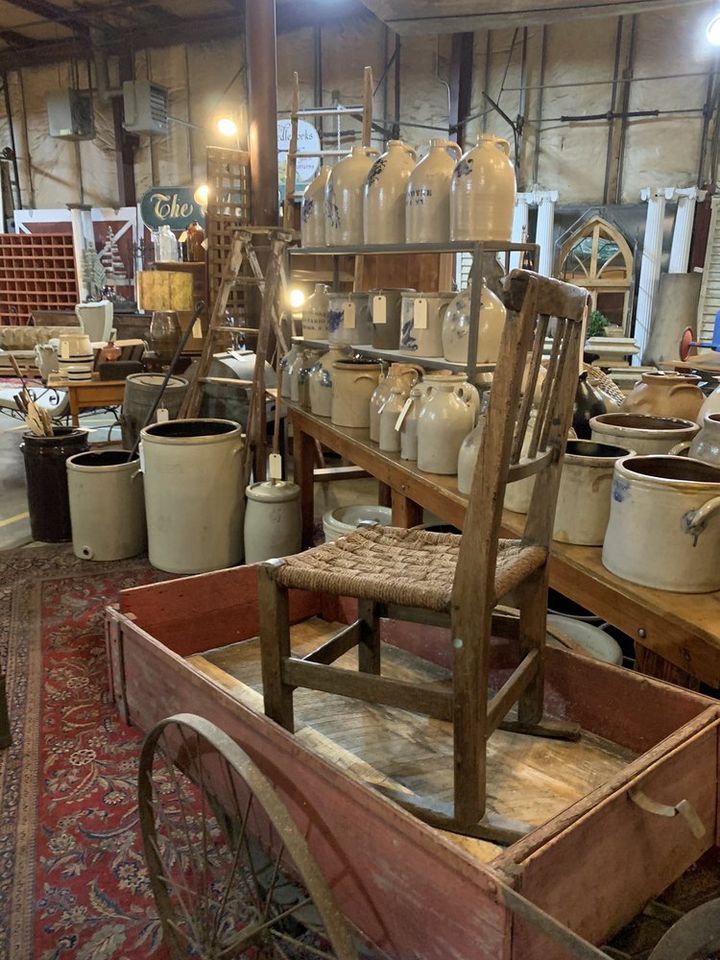 an old wooden wagon filled with lots of jugs