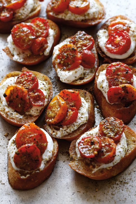 toasted bread topped with tomatoes and cream cheese