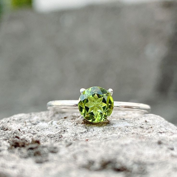 This Small Peridot Ring is handmade from Natural Peridot Gemstone. If you are looking for a  Peridot Ring Silver, August Birthstone Ring, Peridot Rings For Women, Peridot Ring Vintage, or Mother's Ring, this ring will be an excellent choice. Known as the stone of compassion, peridot is believed to bring good fortune, prosperity, emotional healing, and playfulness. Peridot is sure to stabilize your moods and encourage you to bask in the glow of a life well-lived. Ring in Detail: - Gemstone: Peridot - Stone size: Round Cut 6mm - Material: S925 solid silver The ring band is 1.6mm x 1.3mm. Available in Sizes 6 7, 8, 9, 10, 11  for the most optimal fit.   HOW TO MEASURE YOUR RING SIZE: RINGS are generally measured using the diameter, the easiest way to determine this is by measuring a ring you Lime Green Peridot Birthstone Ring For May, Classic Peridot Green Rings, Silver Peridot Ring With Round Cut, Classic Green Peridot Ring, Peridot Rings, Silver Peridot Rings With Polished Finish, Mother's Ring, August Birthstone Ring, Mothers Ring