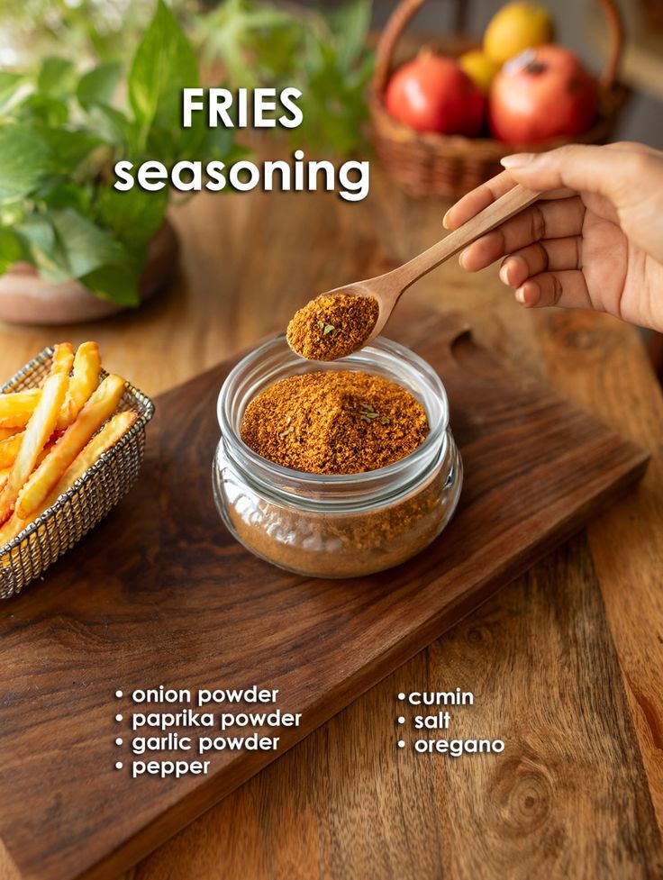 a person is spooning some seasoning into a glass jar on a cutting board