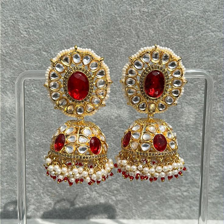 Handmade Style: Traditional Kundan Jhumka Earrings Material: 18k Yellow Gold Plated, Lab Simulated Ruby Stones, Kundan Stones, Pearls Imported Item Number: 7073R Festive 22k Gold Red Earrings, Red 22k Gold Earrings For Wedding, Red 22k Gold Wedding Earrings, 22k Gold Meenakari Earrings For Navratri, Festive Yellow Gold Chandbali Earrings, Bollywood Style 22k Gold Wedding Earrings, Yellow Gold Chandbali Earrings For Navratri, 22k Gold Earrings For Navratri Celebration, Heavy 22k Gold Earrings For Diwali