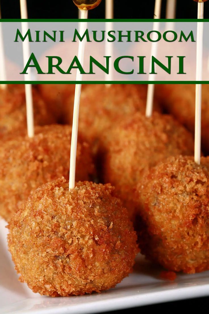 mini mushroom arancini on a white plate with toothpicks