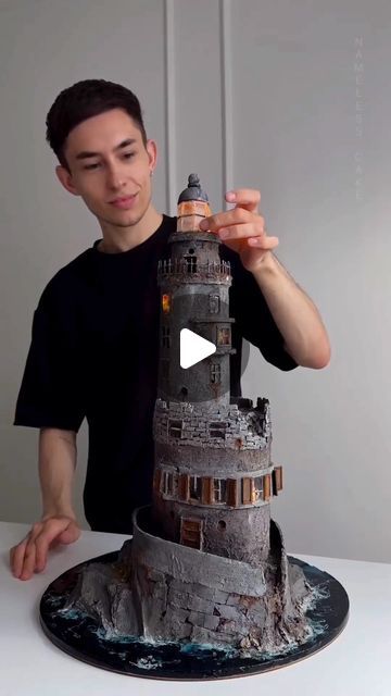 a man is making a model of a tower