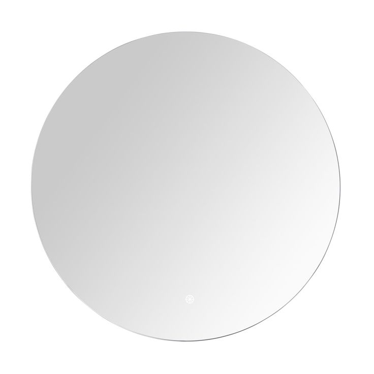 a white round mirror sitting on top of a table