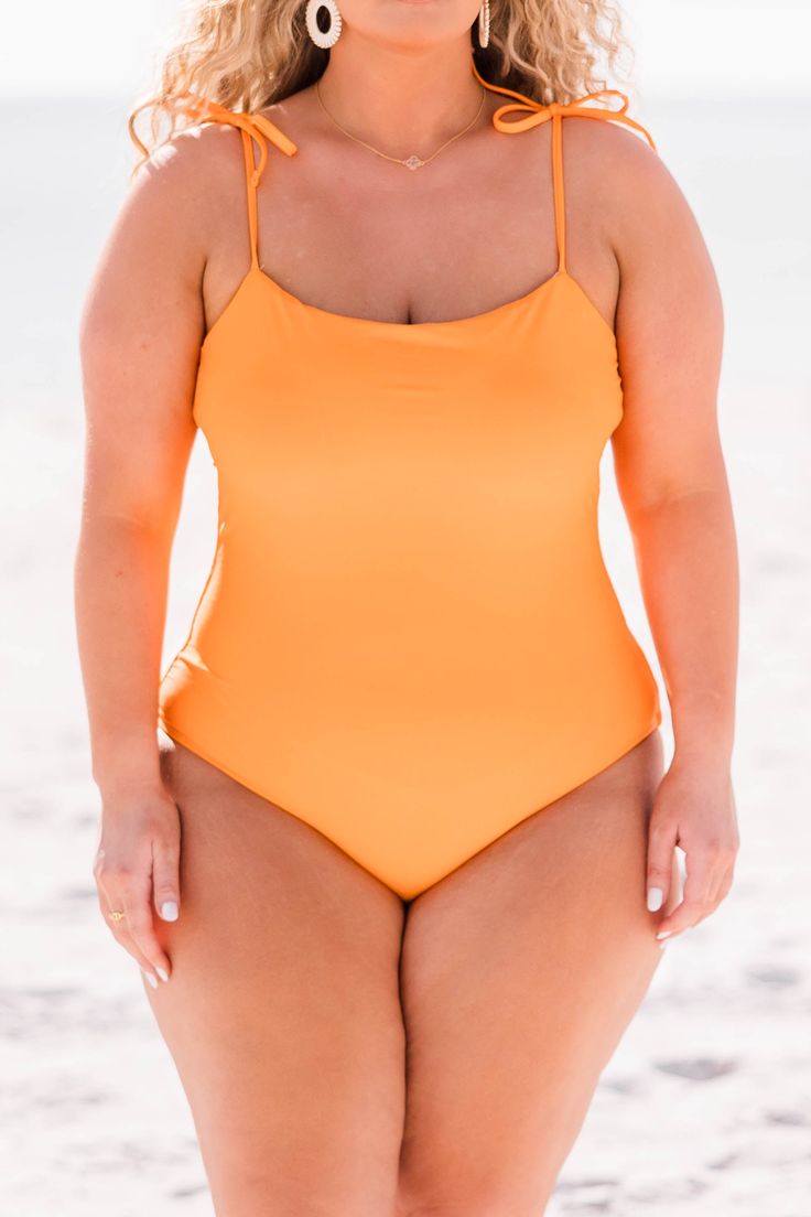 This suit is sure to be your go to style for your new fresh seaside look. The design allows for the perfect amount of coverage while sporting cute tie straps with a vibrant orange color! Whether you decide to lounge in the cabana or relax poolside, you are ready for all things summer with this beauty! 80% Nylon, 20% Spandex Beachy Swimwear With Spaghetti Straps For Pool, Casual Swimwear For Lounging During Beach Season, Casual Swimwear For Lounging In Beach Season, Spaghetti Strap Swimwear For Beach Season Poolside, Spaghetti Strap Swimwear For Poolside And Beach, Solid Color Swimwear With Spaghetti Straps For Sunbathing, Orange Stretch Swimwear For The Pool, Orange Stretch Swimwear For Pool, Fitted Summer Swimwear For Lounging