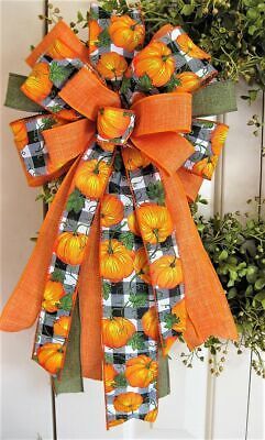 an orange and black bow with pumpkins on it