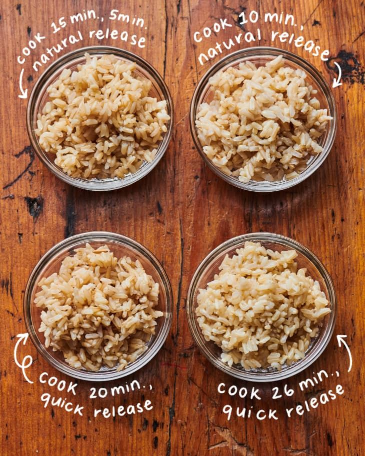 four glass bowls filled with rice on top of a wooden table