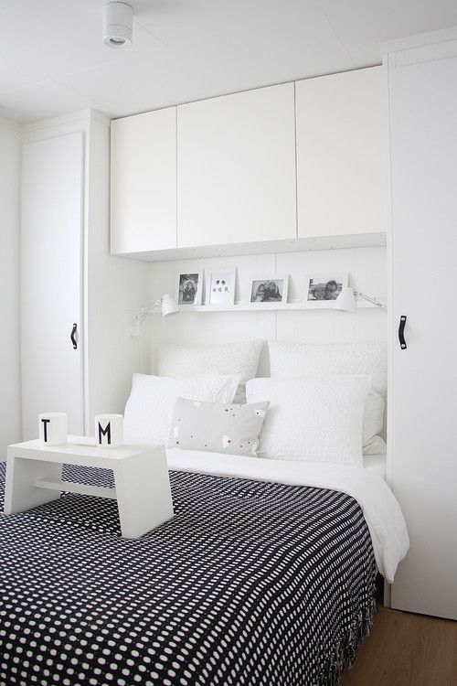 a white bed with black and white bedspread