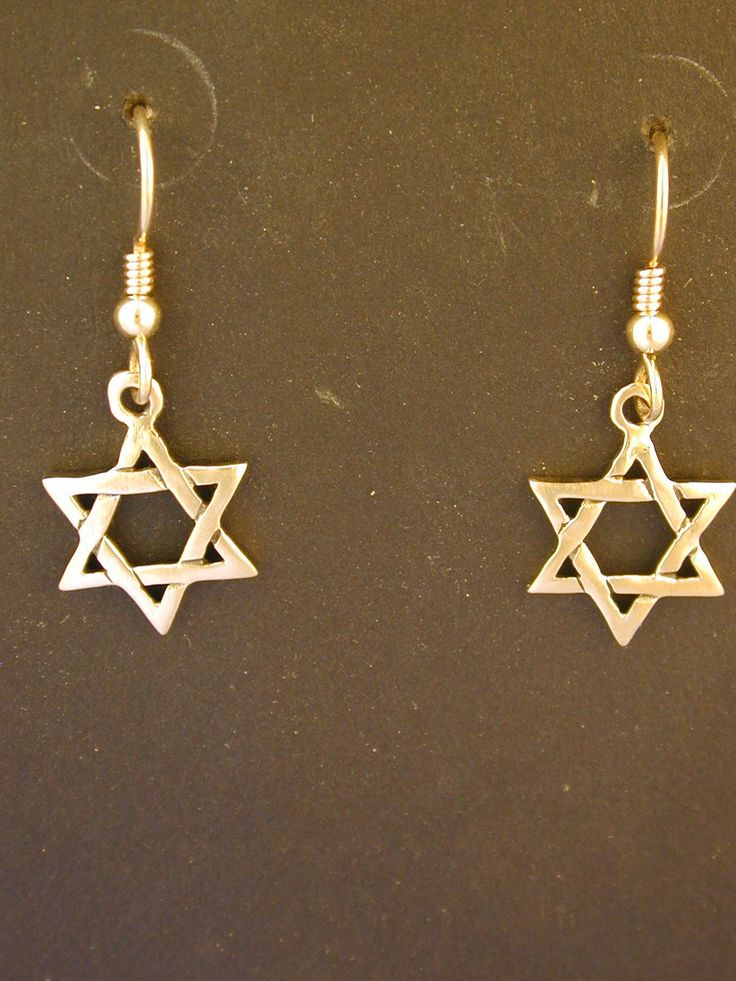 "This Star of David pendant is 14K Gold. The Heavy French Wires are 14K Gold. This Star of David measures 5/8' across and 5/8\" tall. I hand cast all my pieces using the lost wax casting method. Please ask your needs. You may call me with questions, often I am out so please use my machine. 831-476-3176. Satisfaction Guaranteed! This piece is made and ready to ship I send items USPS First Class unless otherwise directed. I send as soon as I can, usually in one to five days. I do shows and am out 14k Gold Star Shaped Pierced Jewelry, Symbolic Nickel-free Star Earrings, Symbolic Star-shaped Nickel-free Earrings, Nickel-free Star Shaped Symbolic Earrings, Silver Star Of David Pendant In 14k Gold, Silver Star Of David Jewelry In 14k Gold, Silver Star Of David 14k Gold Jewelry, Silver Brass Jewelry With Star Charm, Silver Star-shaped Brass Jewelry