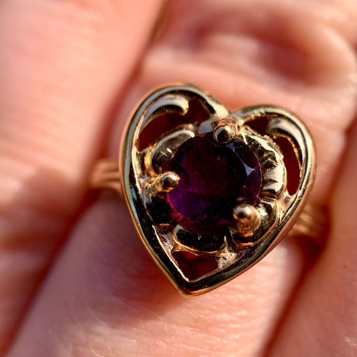 FREE shipping on all orders! FREE 5 Day Returns! Learn More. From our Vintage collection, one-of-a-kind, the perfect gift for Valentine's Day! Gift that special someone a lovely vintage heart design amethyst ring! Our Sweetheart Amethyst 14K Yellow Gold Vintage Ring is a size 5.75 and showcases a 5.00 MM round faceted amethyst set in a circle within a heart motif. The heart wants what the heart wants. Amethyst is February's birthstone so this vintage ring also makes a great birthday gift for those February birthdays! Size: 5.75 Hallmarks: ESEMCO 14K Total Piece Weight: 1.20 dwt #DoGood: We donate 2% of monthly SALES to Girls Not Brides org members. Vintage jewelry may contain minor markings and/or imperfections throughout. Due to the fact that gemstones and metal content can be challenging Heart-shaped Amethyst Ring For Valentine's Day, Heart Shaped Amethyst Ring For Valentine's Day Gift, Heirloom Heart Ring With Birthstone For Valentine's Day, Heirloom Heart-shaped Gemstone Ring, Purple Heart Cut Heart Ring As Gift, Heirloom Jewelry For Valentine's Day, Valentine's Day Heirloom Heart Ring With Birthstone, Vintage Gold Amethyst Birthstone Ring, Elegant Heart-shaped Amethyst Ring For Valentine's Day