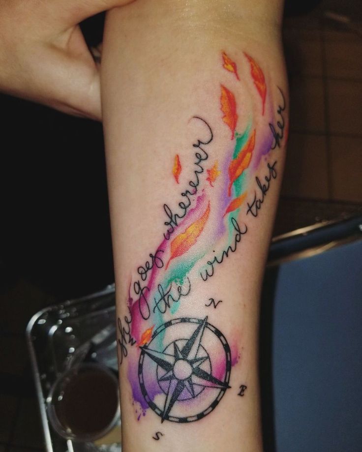 a woman's arm with a colorful tattoo on it