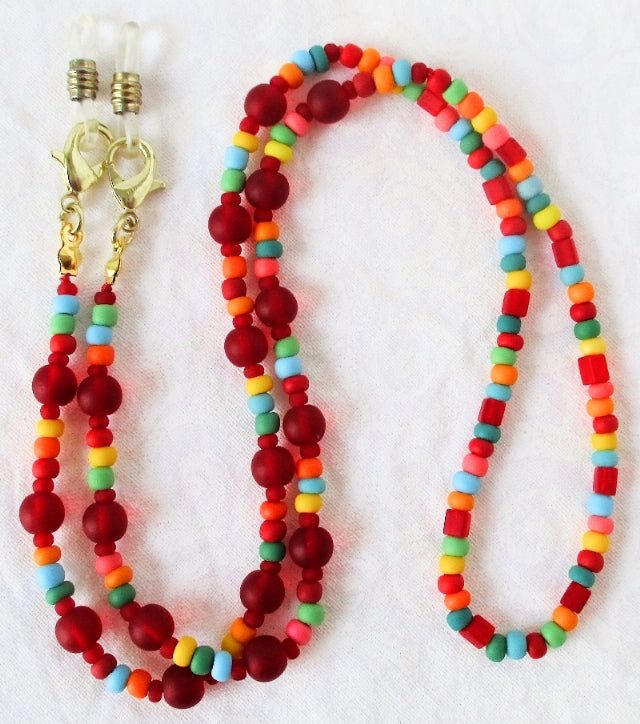 Red/Multicolor Beaded Eyeglass Chain 25.5" in length, made with glass beads, beading cord, metal lobster clasps, and adjustable rubber holders. Lobster clasps make it easy to change the rubber holders, and an extra pair of holders are included with every purchase. You can convert this eyeglass chain into a convenient mask chain as well! Simply remove the rubber holders from the lobster clasps, and replace them with face mask straps, as shown. You'll never mis-place your mask again, and always ha Beading Cord, Eyeglass Chain, Colored Glass, Gift Box, Beaded Jewelry, Glass Beads, Chain, Beads, Red