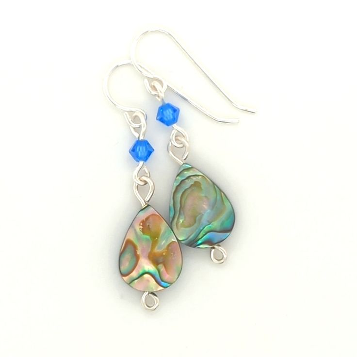 Elevate any look with my elegant Sterling Silver Abalone Dangle Earrings. Featuring a spinning abalone teardrop bead and a dark teal crystal accent, these ladies earrings are sure to impress. Choose from a large or small shell drop style to match your unique style. Abalone Shells - A sacred symbol of the sea. They help strengthen love within, foster interpersonal harmony, release negative feelings and ease stressful situations. Sterling Silver Teardrop Beaded Earrings, Iridescent Pearl Drop Dangle Earrings, Teardrop Mother Of Pearl Ear Wire Jewelry, Elegant Nickel-free Shell Earrings, Abalone Shell Drop Earrings, Elegant Handmade Abalone Shell Earrings, Handmade Mother Of Pearl Teardrop Earrings, Abalone Shell Dangle Jewelry, Elegant Abalone Shell Earrings For Pierced Ears