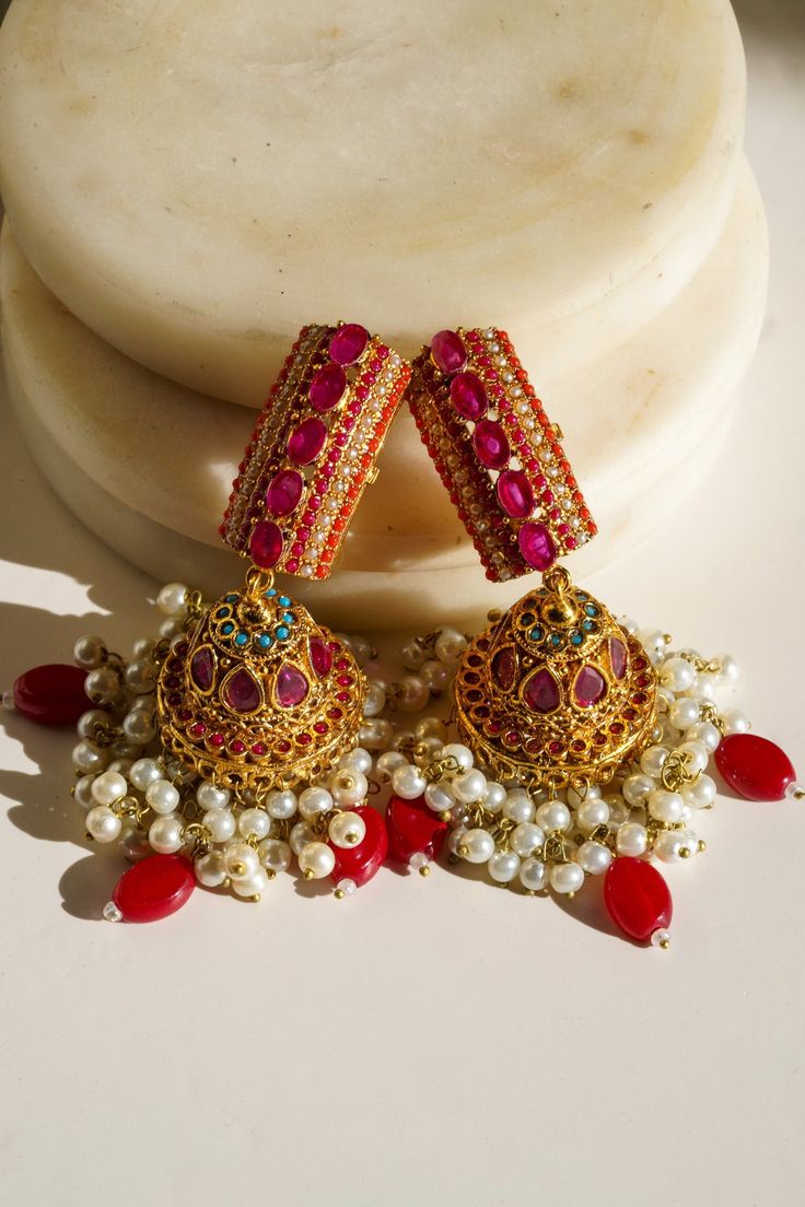 Elevate your style with our exquisite "Navdeep Jhumka Earrings." These heritage-inspired jhumka earrings are the perfect fusion of tradition and elegance. Crafted to perfection, they come in three primary color options, all in gold plating: ruby, blue, or gold, allowing you to choose the perfect match for your ensemble. Key Features: Color Options: Available in ruby, blue, or gold Dimensions: Approximately 3.5 inches Embellishments: Adorned with beautiful multi-color stones and embellishments Qu Three Primary Colors, Jhumka Earrings, Style Classique, Champagne Gold, Blue Gold, Perfect Match, Blue Sapphire, Primary Colors, Color Options