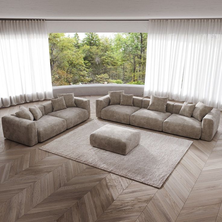 a modern living room with chevron wood flooring and large windows overlooking the forest