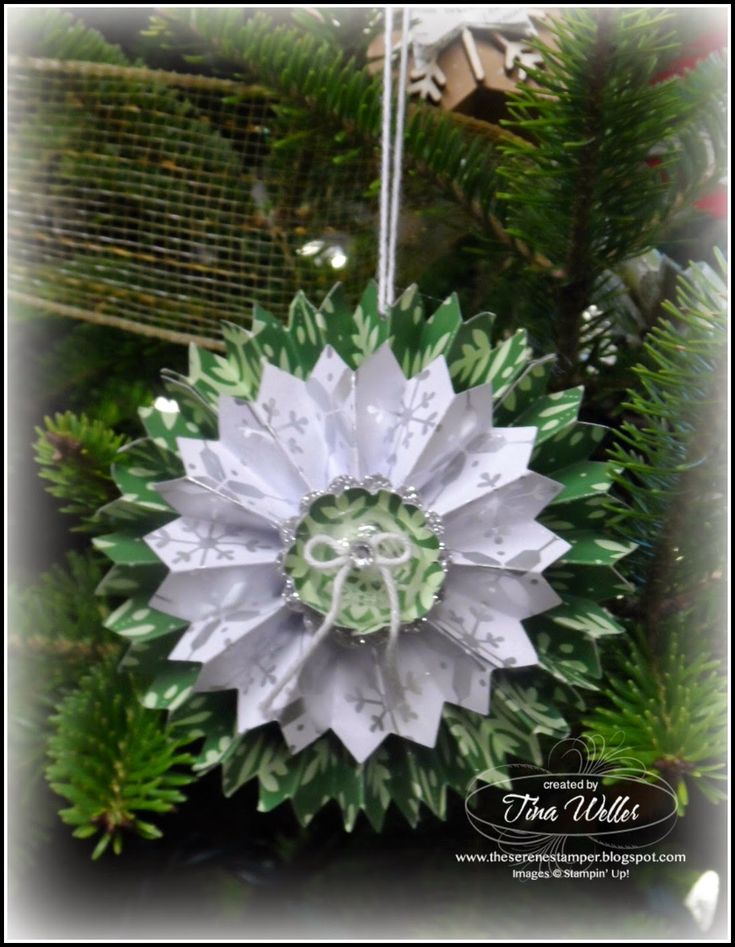 an ornament hanging from a christmas tree in the shape of a large flower