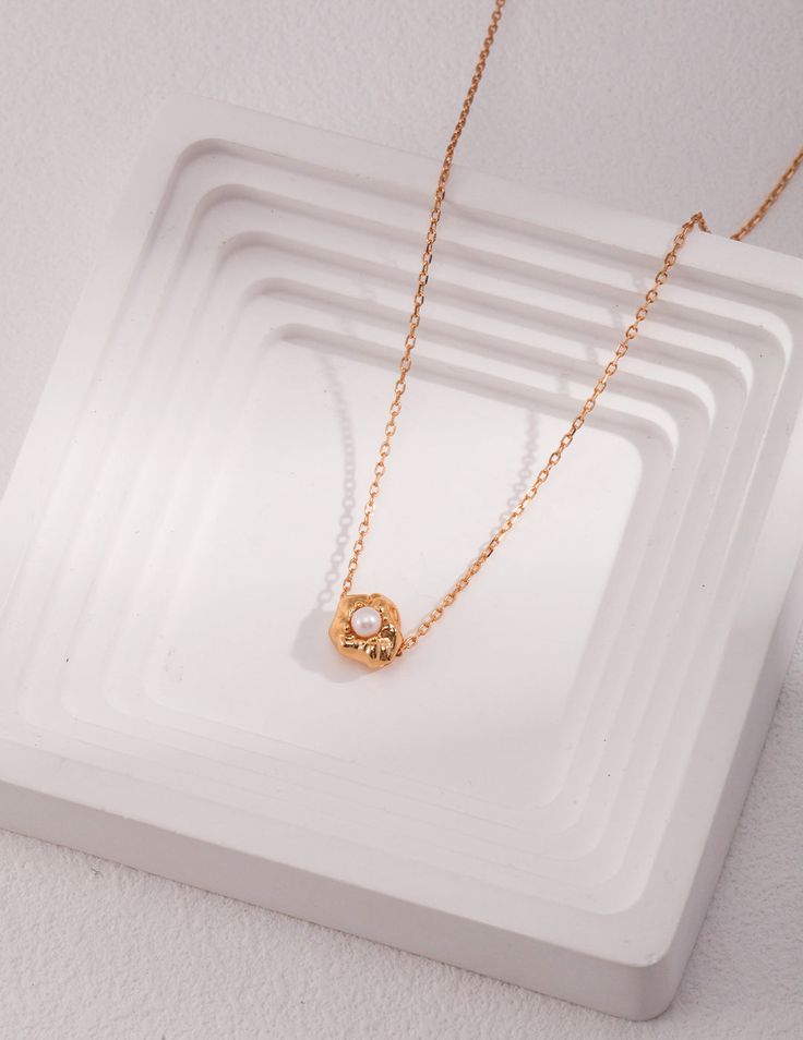 The Classic Beauty Of A Single Pearl Necklace Embedded In Gold Stone Introducing the Single Pearl With Gold Stone Pendant Necklace by Señorita J. This piece is a perfect blend of classic elegance and modern style. The pendant features a single, well-formed, round pearl that sits securely in a gold bezel setting, adding to its durability and appeal. The surface of the charm is thoughtfully designed with a slight indentation or texture to enhance the pearl's visual impact. This gold necklace has a Rose Gold Necklaces With Pearl Charm, Rose Gold Round Necklaces With Pearl Charm, Elegant Pearl Jewelry In Circle Shape, Elegant Pearl Circle Jewelry, Elegant Circular Pearl Jewelry, Elegant Circle Pearl Jewelry, Elegant Circle Necklace With Adjustable Chain, Rose Gold Round Pearl Necklace With Clavicle Chain, Elegant Gold Plated Circle Necklace