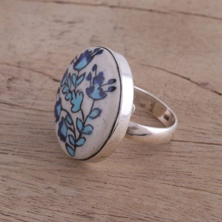 Circling the finger with sterling silver, this cocktail ring is crowned with a disc of ceramic, hand-painted with dancing floral motifs. Anuva Baid presents this accessory, working from the royal city of Rajasthan in India. Hollow Form, Silver Cocktail, Bezel Ring, Ceramic Set, Cocktail Ring, Cocktail Rings, Floral Painting, Floral Motif, Beautiful Jewelry