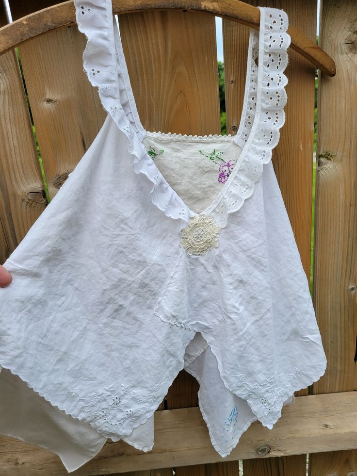 Handmade from vintage handkerchiefs, cropped, oversized style tank top. Layering piece with Magnolia Pearl vibe and antique look.  Some small signs of aging, such as tiny holes and tiny discoloration spots. Super soft and flowey. Hand embroidery.  It was washed after making and since it is a vintage textile and delicate in nature, I recommend hand washing and hanging to dry.  Women's size - Medium to Large Approximate measurements: All taken laying flat, from side to side Length - uneven 17" to Summer Cotton Lace Tops With Crochet Trim, Bohemian Cotton Tops With Lace Trim, Bohemian Cotton Top With Lace Trim, Cotton Lace Trim Crop Top Tank, Cottagecore Summer Beach Tops, Cotton Tank Tops With Crochet Trim, Sleeveless Cotton Crochet Top With Lace Trim, Cotton Crochet Trim Tank Top, Vintage Lace Trim Tank Top