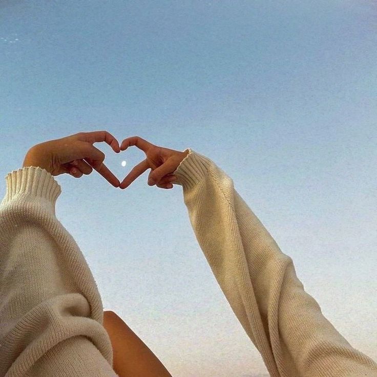 two people making a heart with their hands