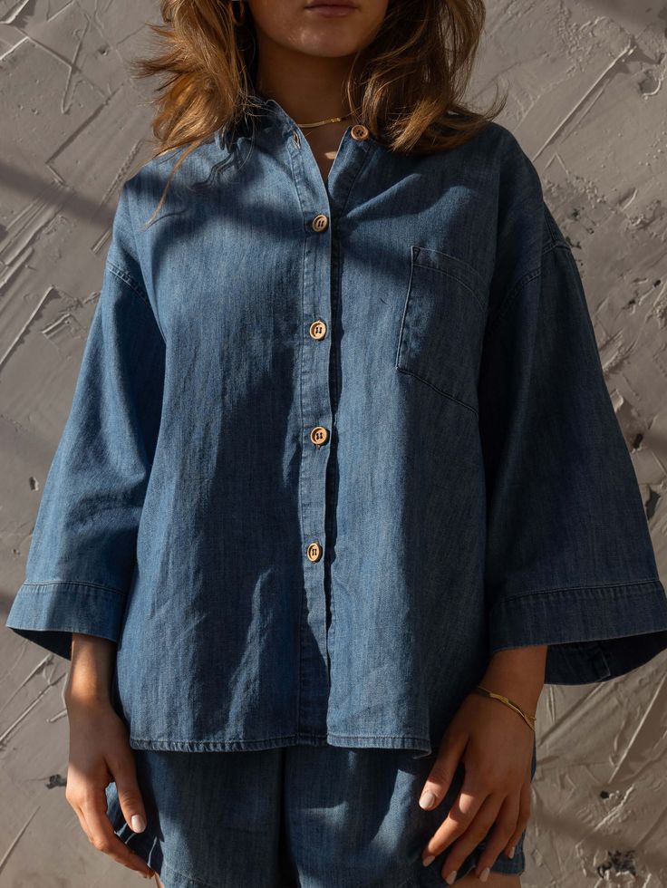 Meet our best-selling Linen Shirt, now in soft, denim chambray! This relaxed-fit button down-shirt for women has wide sleeves and a boxy fit that makes it the perfect everyday piece for the warm weather. We love it paired with The Chambray Denim Short or The Wide Leg Jean.Our small-batch wash process means that each of our denim garments will vary slightly in color and appearance.• Composition: 100% cotton• Available in: MID DENIM• US sizes: XS (US 0–2), S (US 4–6), M (US 8–10), L (US 12–14), XL Washed Blue Chambray Button-up Top, Medium Wash Relaxed Fit Button-up Shirt, Light Wash Oversized Tops For Everyday, Oversized Light Wash Tops For Everyday, Trendy Relaxed Fit Everyday Denim Top, Relaxed Fit Light Indigo Button-up Top, Light Indigo Relaxed Fit Button-up Top, Relaxed Fit Washed Tencel Tops, Relaxed Fit Chambray Top With Button Closure