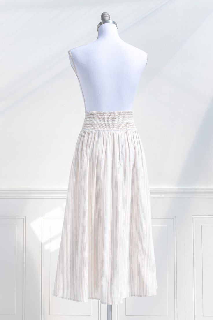 A must-have in the vintage-inspired wardrobe, the Sasha midi skirt in cream striped cotton features a faux button front, a fitted high waist, and a smocked elastic back for a comfortable fit. Perfectly paired with a knit top and ballet flats for a retro springtime look! . Details: S: Waist 26"-30", Length 33" M: Waist 28"-32", Length 33.5" L: Waist 30"-34", Length 34" Elastic Back Waistline Unlined Material: 100% Cotton Care: Hand Wash Cold / Hang Dry Imported Ships in 1 to 2 Business Days Free Relaxed Cream Cotton Skirt, Cream Cotton Relaxed Skirt, Beige Midi Length Cotton Skirt, Beige Cotton Gathered Skirt, Beige Vintage Cotton Skirt, Cottagecore Clothes, Cotton Midi Skirt, Cottagecore Style, Ballet Flats