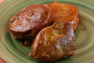 two pieces of meat sitting on top of a green plate