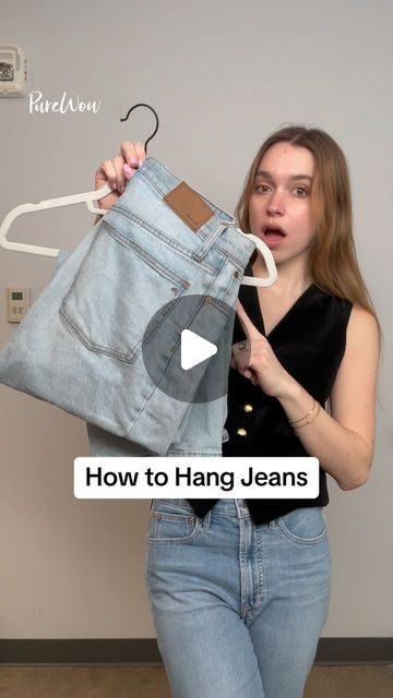 a woman holding up a pair of jeans in front of her face with the words how to hang jeans