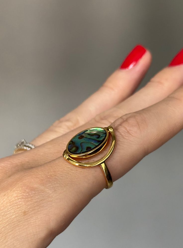 Discover the exquisite elegance of our Abalone Shell Ring, featuring a versatile double-sided design with natural abalone and white shells. Crafted from high-quality brass plated with 18K gold, this luxurious piece embodies nature's beauty and fine craftsmanship. Specifications: - Item Weight: Lightweight and comfortable at 0.06 mils of gold plating. - Metals Type: Stainless Still. - Material: 18K gold plated, combined with natural abalone and white shell. Care Instructions:  * Protect your jewe Gold Shell-shaped Ring For Gift, Unique Gold Jewelry With Abalone Shell, Gold Shell-shaped Gift Ring, Elegant Shell-shaped Ring For Gifts, Gold Mother Of Pearl Ring As A Gift, Gold Mother Of Pearl Rings For Anniversary, Gold Mother Of Pearl Anniversary Rings, Gold Abalone Shell Round Jewelry, Elegant Gold Abalone Shell Jewelry