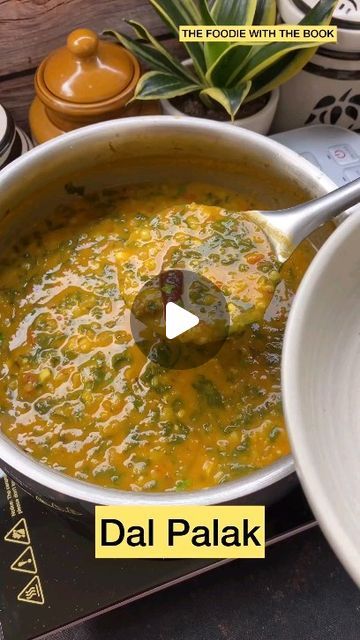 a bowl of soup with a ladle in it and the words dal palak