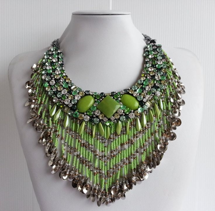 Each piece of our statement necklaces is handmade and one of a kind made in Italy. Our creations is made of high quality materials such as crystals and rhinestones. Each embroidered material is carefully hand sewn. Very glamorous and stylish. Perfect gift to someone you like. Materials Strass stones in Crystal, Emerald and Peridot color in different shape and dimension. Jeweled fringe with Light Green, Silver and Bronze beads.  Black satin fabric backing. Aluminium chain with lobster closure. Measurements Weight approximate 150 grams. Chain lenght 24 cm - 9,448 in Circumference approximate 57 cm - 22,440 in Feel free to contact us if you have any question. Thank you so much for looking at our shop and our articles each of them, single piece. Bohemian Crystal Necklaces With Rhinestones, Embellished Crystal Necklaces For Gift, Jeweled Crystal Beaded Costume Necklace, Crystal Beaded Costume Jewelry Necklace, Black Satin Fabric, Peridot Color, Diamond Heart Pendant Necklace, Satin Noir, Necklace Collar