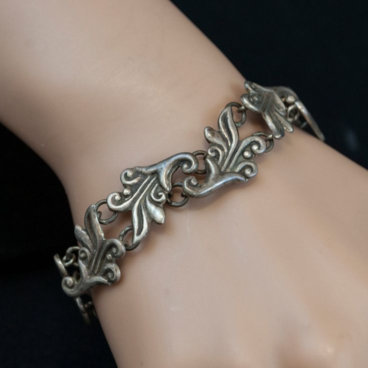 This beautiful sterling silver link bracelet is a wonderful addition to any outfit. Each link has a wonderful carved floral design.  Sterling Silver Elegant Charm Bracelet With Sterling Silver Clasp, Elegant Engraved Oval Link Sterling Silver Bracelet, Elegant Engraved Sterling Silver Oval Link Bracelet, Classic Engraved Sterling Silver Bracelet, Ornate Sterling Silver Bracelets With Silver Clasp, Ornate Sterling Silver Bracelets, Formal Engraved Link Bracelets, Classic Engraved Charm Bracelet For Formal Occasions, Elegant Engraved White Gold Charm Bracelet