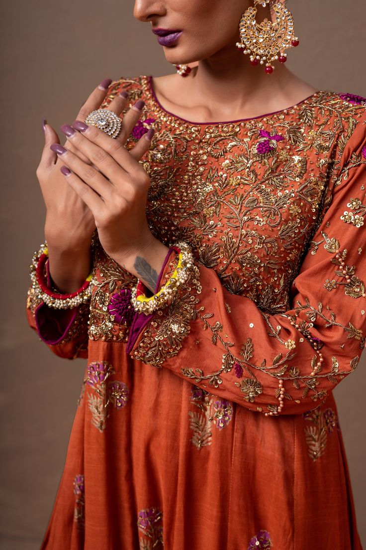 A beautiful vermillion colored, hand-embroidered dress ideal for weddings. The raw silk block-print fabric features ethnic embroidery on the front of the body, and the touch of handwork gives it a beautifully traditional look.3-Piece SuitReady to wear Anarkali Art Silk Dress With Intricate Embroidery, Festive Art Silk Dress With Intricate Embroidery, Festive Dresses With Intricate Embroidery In Art Silk, Diwali Art Silk Dresses With Intricate Embroidery, Embroidered Anarkali Dress In Art Silk, Festive Raw Silk Dress With Intricate Embroidery, Art Silk Straight Kurta With Intricate Embroidery, Bollywood Style Silk Dress With Intricate Embroidery, Intricate Embroidery Art Silk Straight Kurta Dress