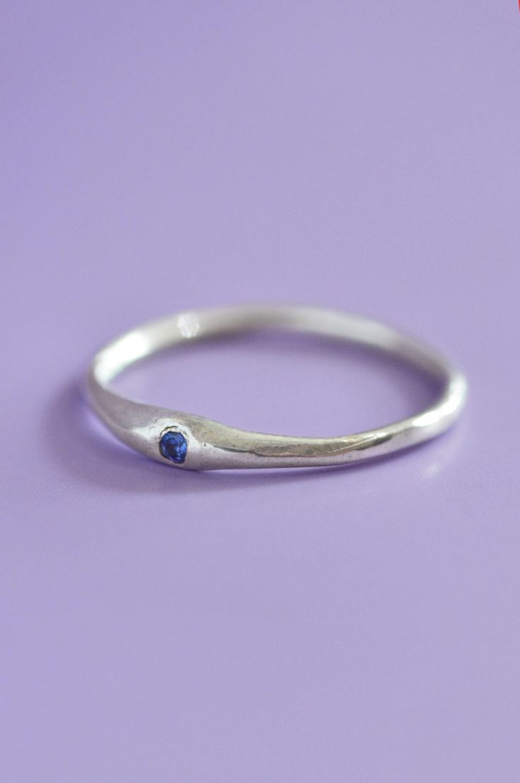 The Siyum gem ring is a true minimalist piece, a fine seamless round band is hand brushed finished allowing a contemporary aesthetic. Perfect for everyday, once you take it off you won't take it off! A petite round blue Sapphire adds a beautiful detail and personalised touch. Use the drop down to select your ring size.If you are unsure of your ring size refer to our size guide. Please select your ring size carefully, and reach out if you have any questions. DetailsSterling Silver Handcrafted in Sapphire Silver Ring, Gem Ring, Contemporary Aesthetic, Blue Sapphire, Silver Ring, Size Guide, Sapphire, Ring Size, Silver Rings