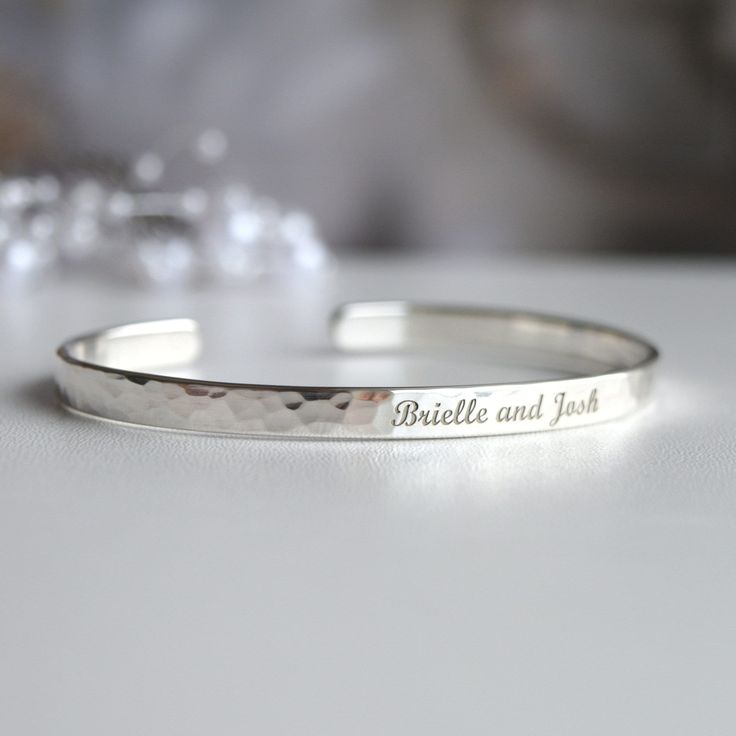 If you're wondering what to get a future Daughter in Law, here's a very memorable gift. The bracelet comes personalized with any words, symbols or your handwriting.  - Open hammered Sterling Silver bracelet - The bracelet can be engraved with any text, up to 90 characters on each side.  - Many fonts and symbols (and also handwriting) available  If you want to see the draft of the engraving, please send me the text and font via message. I will prepare and send you the draft. You can any text, her Engraved Name Bracelet For Anniversary Mother's Day, Engraved Name Bracelet For Anniversary, Mother's Day Gift, Engraved Name Bracelet For Mother's Day Anniversary, Engraved Name Bracelet For Anniversary And Mother's Day, Silver Engraved Bracelets For Anniversary, Sterling Silver Engraved Bangle For Anniversary, Engraved Bangle For Personalized Mother's Day Gift, Engraved Bangle For Mother's Day Personalized Gift, Mother's Day Engraved Bangle For Personalized Gift