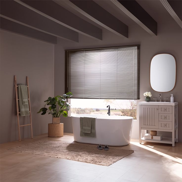 a white bath tub sitting under a window in a bathroom