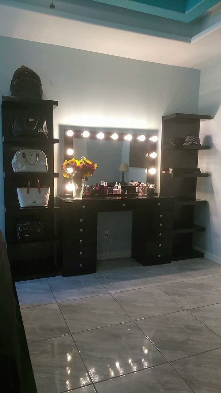 a vanity with lights on it in a room